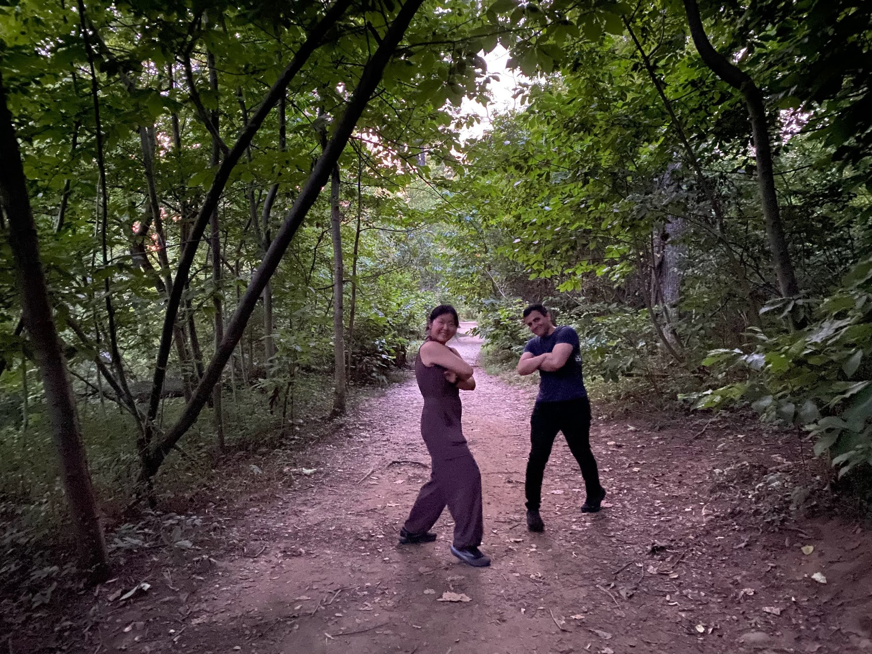 Amirali and a companion posing on a wooded trail