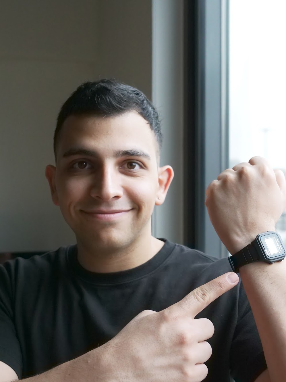 Amirali showing a watch on his wrist